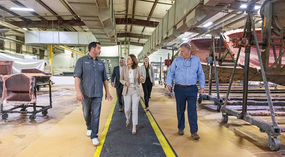President Logan and other guests from the Dallas Fed are given a tour of the Tigé Boats manufacturing facility in Abilene.