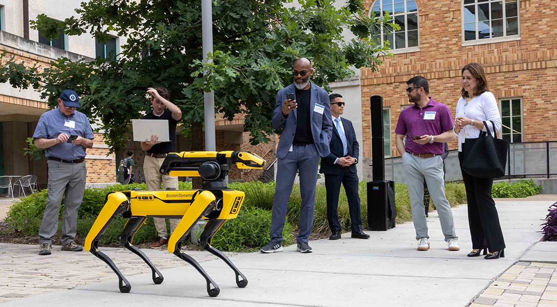 Dallas Fed President Lorie Logan meets a dancing, dog-like robot.