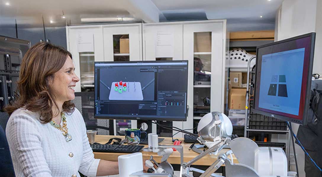 A student demonstrates an AI-equipped robotic prosthetic leg that he and his team made.