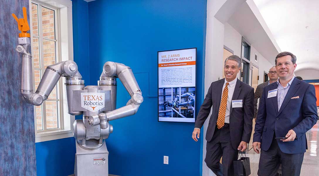 Houston Regional Executive Daron Peschel tours the Texas Robotics facility with fellow UT alum and Dallas Fed Board Member James Hill.