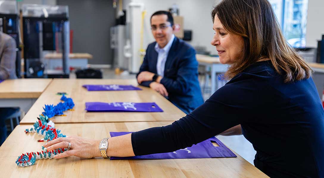 President Logan learns firsthand about an student's 3D-printed project during a tour of Austin Community College's Innovative Manufacturing Partnerships Accelerating Central Texas (IMPACT) Lab..