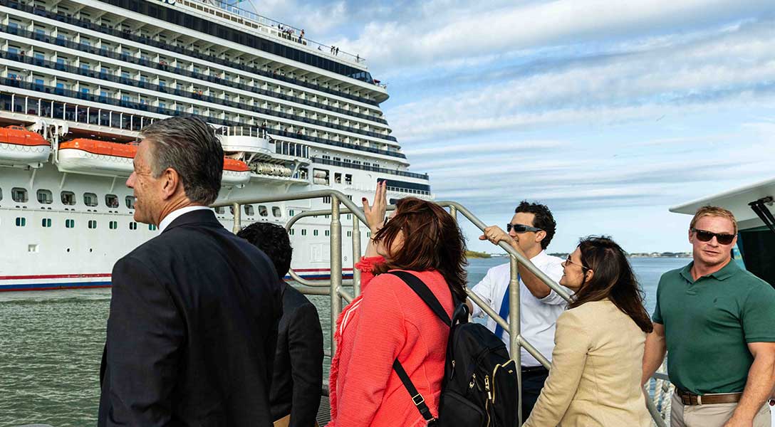 Dallas Fed President Lorie Logan and members of her team and civic leaders watch a cruise ship move through the Port of Galveston.