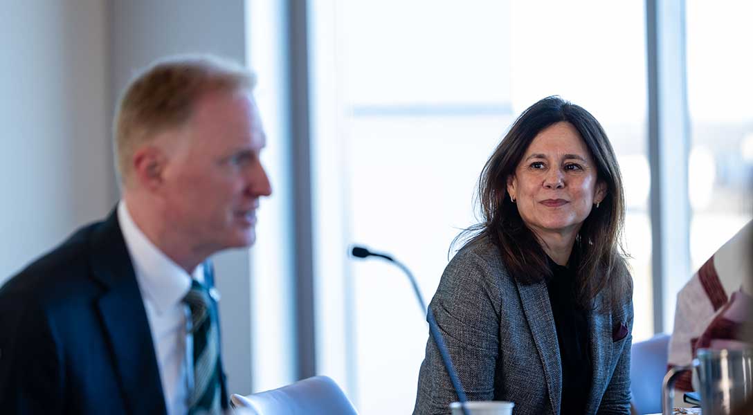 University of North Texas President Harrison Keller (left) speaks during an economic roundtable with Dallas Fed President Lorie Logan and local civic and business leaders.