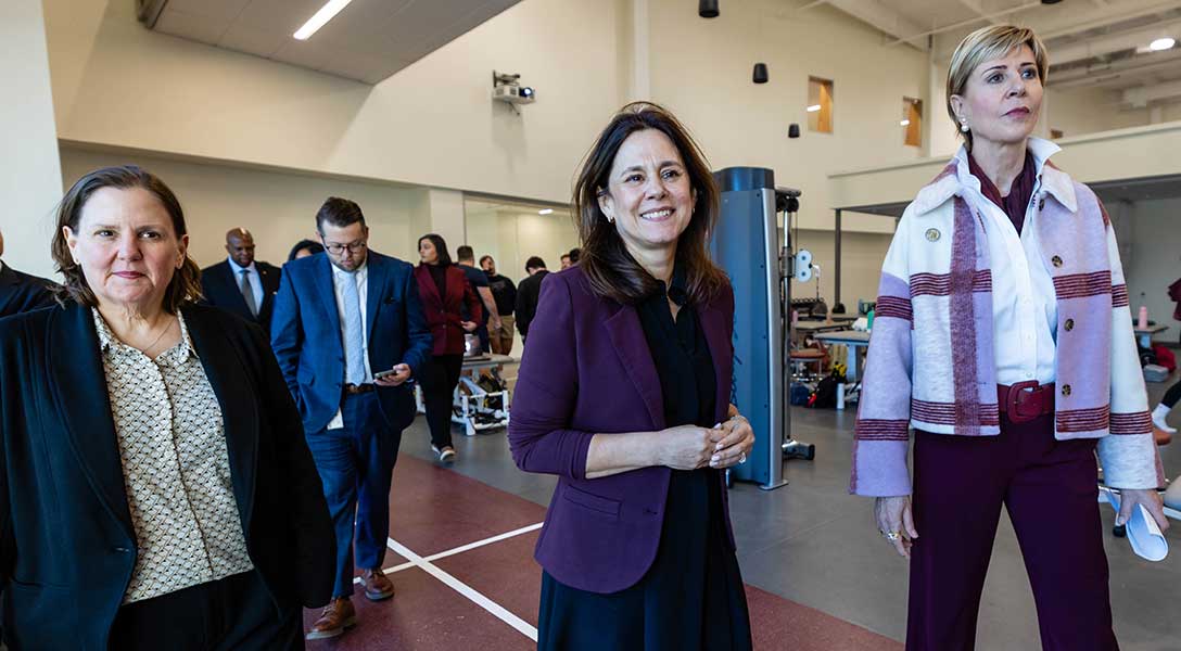 President Logan tours the Texas Woman's University health science building alongside TWU President Carine Feyton (right).
