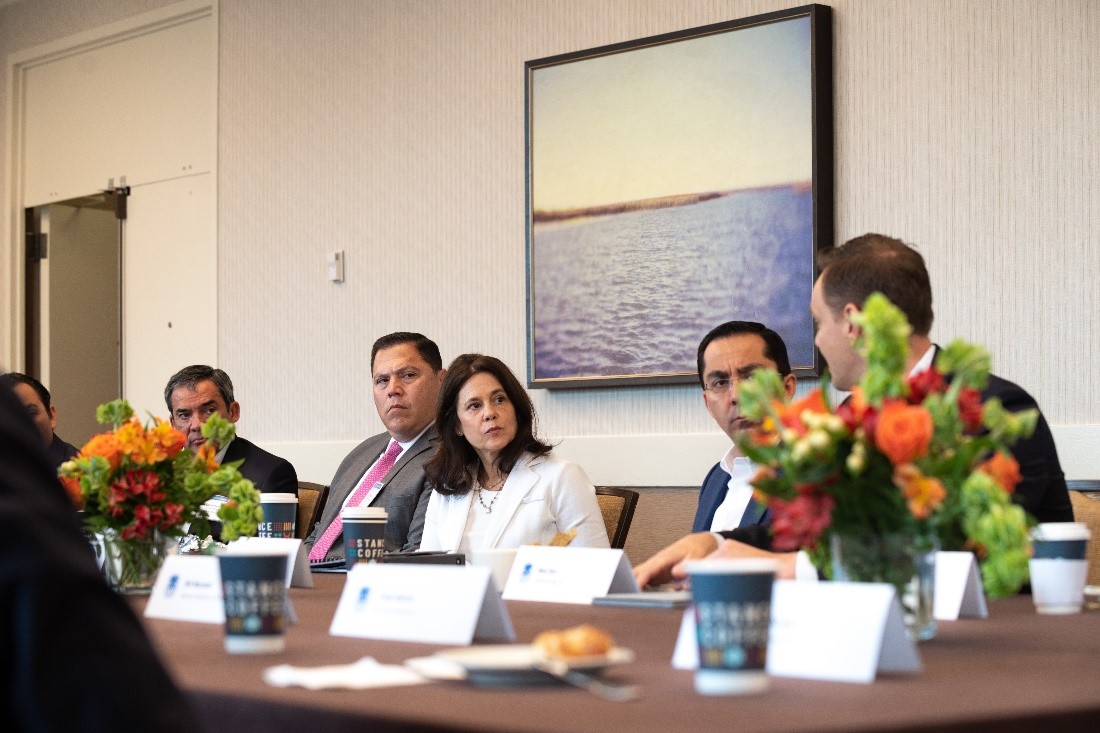 Dallas Fed President Lorie Logan talks with officials during her stop in Corpus Christi