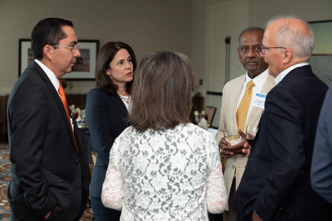 Dallas Fed President Lorie Logan talks with officials during her stop in Corpus Christi