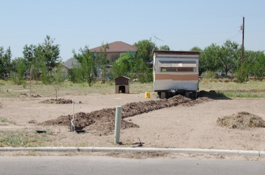 A small, home-constructed pipeline connecting this home to the subdivision's water line